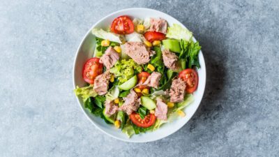 tuna salad with tomatoes, lettuce , and sweetcorn