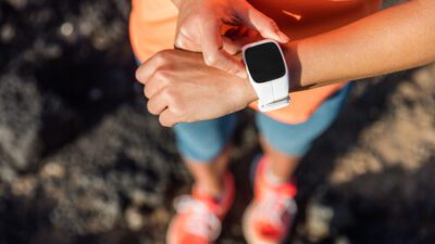 A woman's wrist with a smart watch on monitoring her after she has just gone for a run