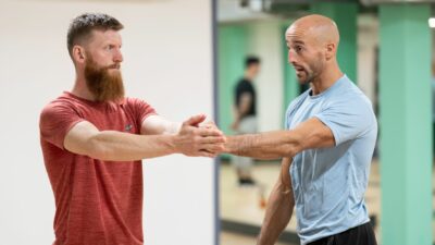 Personal trainer advising on client stretches