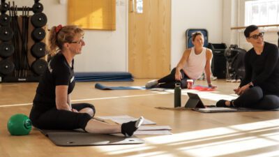 Pilates instructor teaching a class