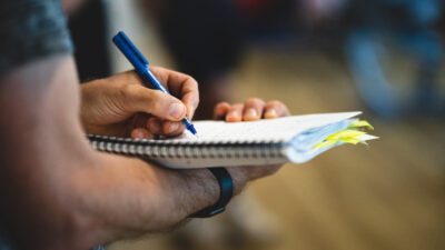 Student taking notes in a notebook