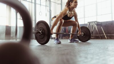 Young Woman lifting weights - future fit training