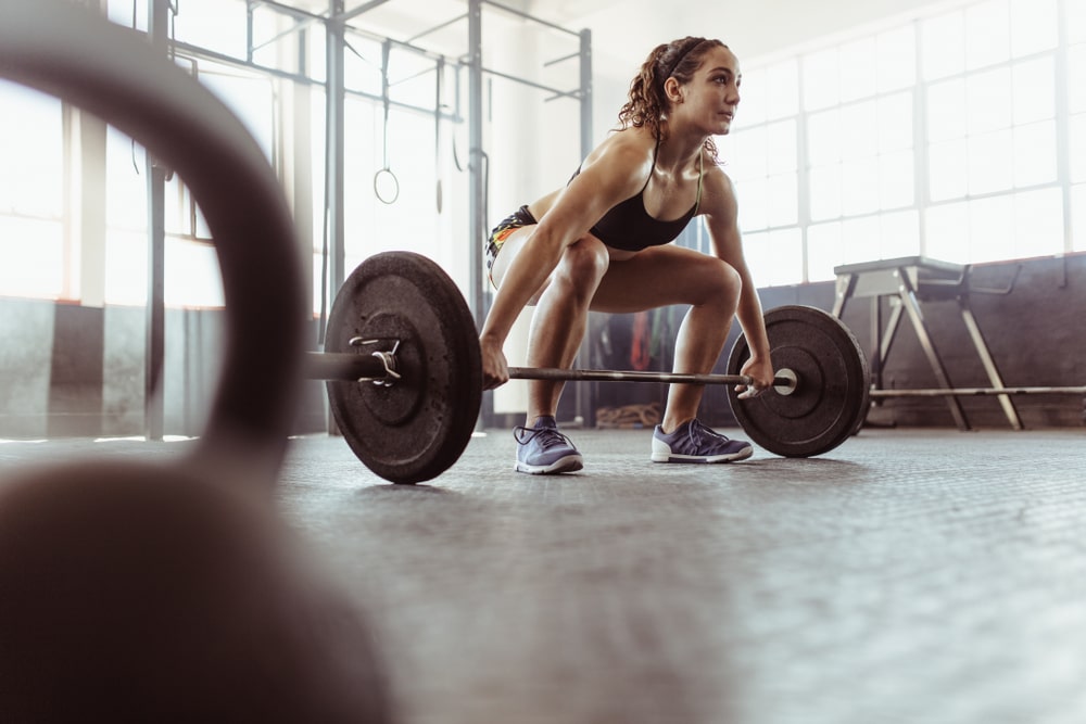 Young Woman lifting weights - future fit training