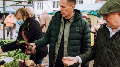 James Ellis and Jason Shaw of Elevated Food for Life browsing at a Farmers' Market