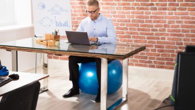 man sitting on fitness ball